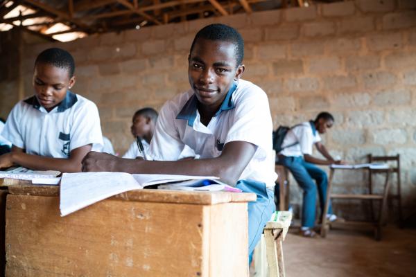 A young boy sits in a classroom in Nigeria.